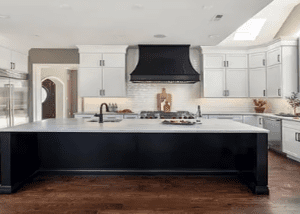 Modern kitchen with large island and hood.
