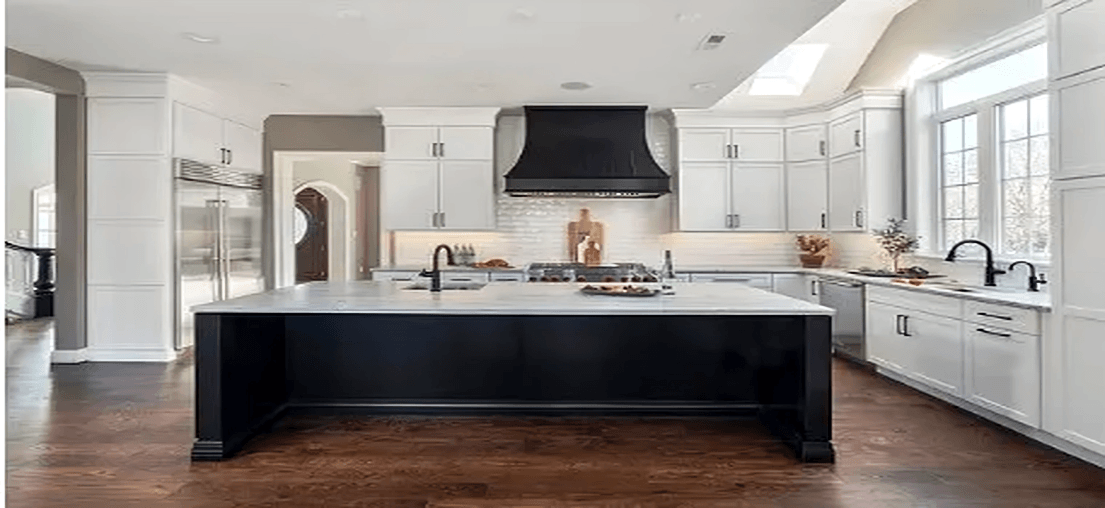 Modern kitchen with large island and hood.
