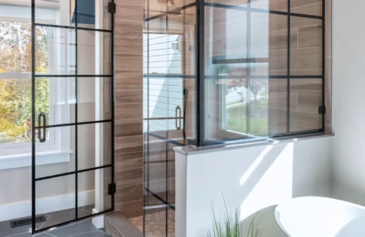 Modern bathroom with glass shower and freestanding tub.