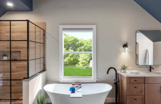 Modern bathroom with a freestanding tub and wooden accents.