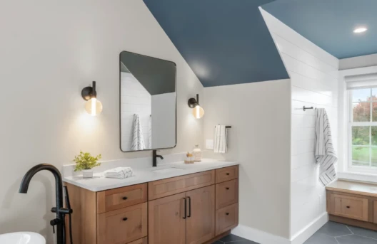 Modern bathroom with wooden vanity and large mirror.