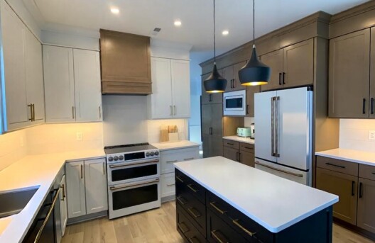 Modern kitchen with island and pendant lights.