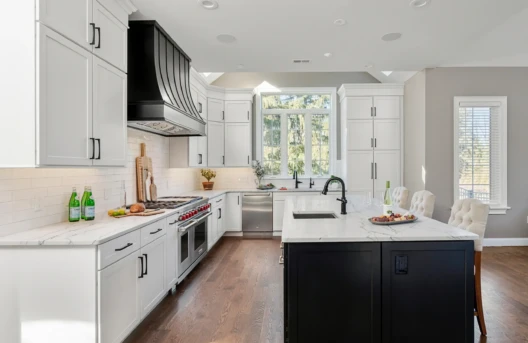 Modern kitchen with island and large window.