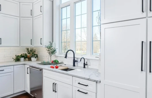 Bright modern kitchen with white cabinets.