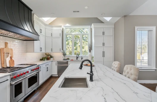 Modern kitchen with marble island countertop.