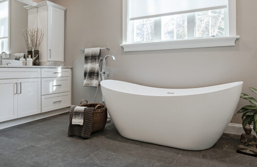 Primary Bathroom Remodel in Lower Gwynned Township, Ambler, PA. Features 4" x 12" Honed White Carrara Marble In The Shower With Full Back-Wall Shelf, Freestanding Tub, Dual Vanities with Marble Tops, Glass Shower Enclosure, and Custom White Cabinetry and Built-In Bench