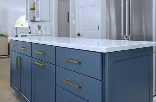 Modern Transitional Kitchen Remodel in Blue Bell, PA With White Shaker Cabinets, Navy Blue Island, Subway Tile Backsplash, and Radiant-Heated Tile Floors