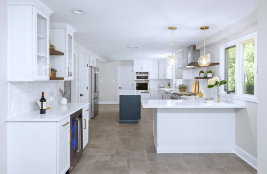 Modern Transitional Kitchen Remodel in Blue Bell, PA With White Shaker Cabinets, Navy Blue Island, Subway Tile Backsplash, and Radiant-Heated Tile Floors