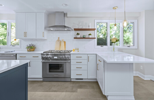 Modern Transitional Kitchen Remodel With White Shaker Cabinets, Navy Blue Island, Subway Tile Backsplash, and Radiant-Heated Tile Floors