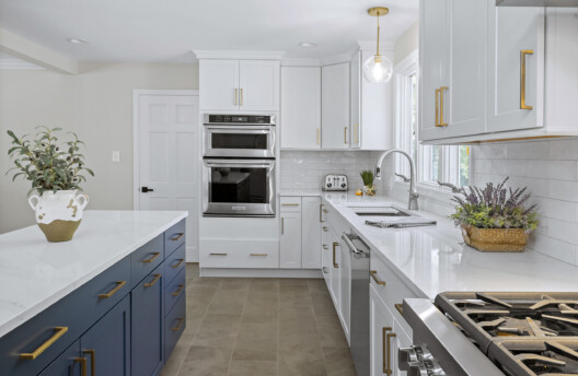 Modern Transitional Kitchen Remodel With White Shaker Cabinets, Navy Blue Island, Subway Tile Backsplash, and Radiant-Heated Tile Floors