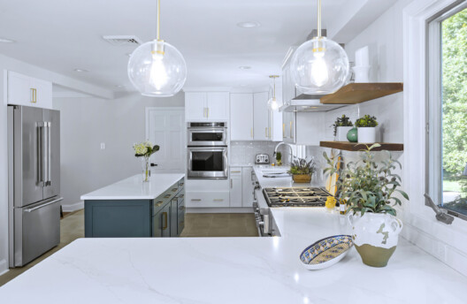 Modern Transitional Kitchen Remodel in Blue Bell, PA With White Shaker Cabinets, Navy Blue Island, Subway Tile Backsplash, and Radiant-Heated Tile Floors