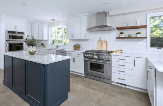 Modern Transitional Kitchen Remodel With White Shaker Cabinets, Navy Blue Island, Subway Tile Backsplash, and Radiant-Heated Tile Floors