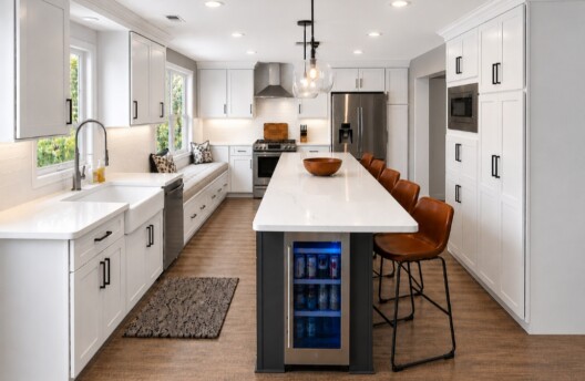 Modern White Kitchen Remodel in Collegeville, PA With Shaker Cabinets, Quartz Countertops, Large Island, and Built-In Window Bench Breakfast Nook