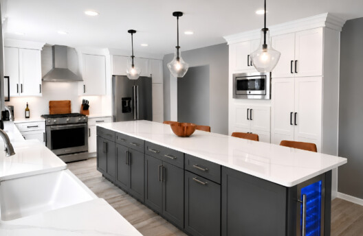 Modern White Kitchen Remodel in Collegeville, PA With Shaker Cabinets, Quartz Countertops, Large Island, and Built-In Window Bench Breakfast Nook